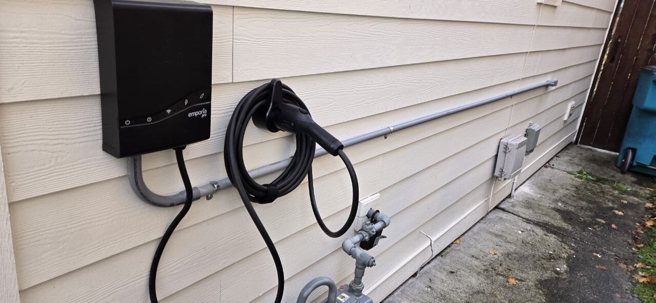 Level 2 EV charger installed on the exterior siding of a Clark County WA home